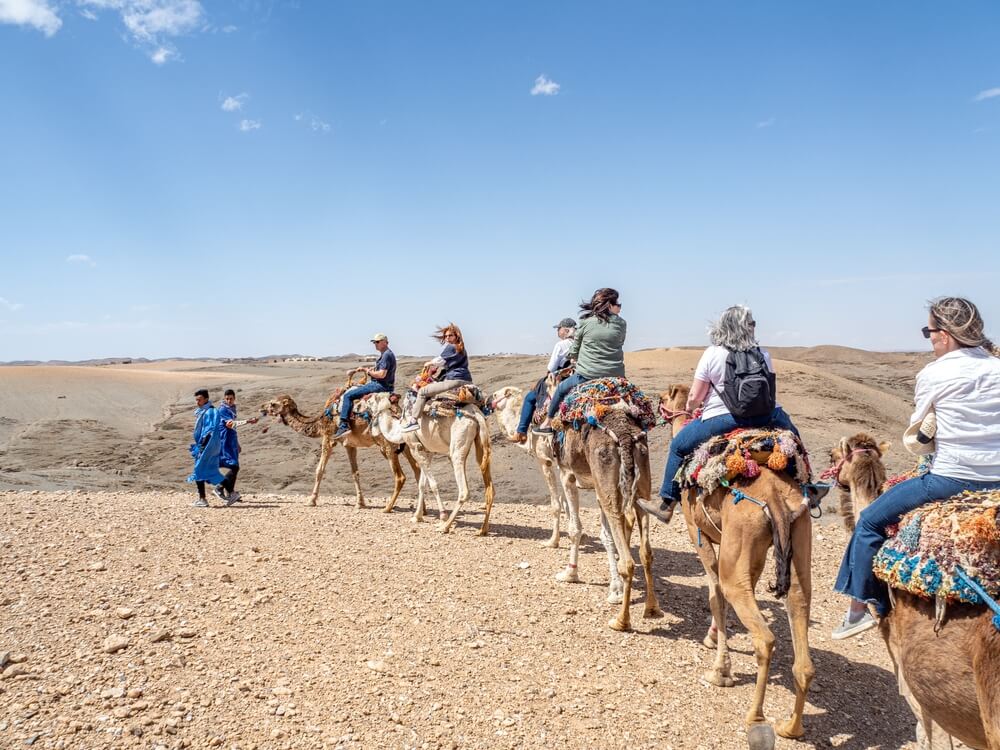 Caravan of tourists start out on camel ride across Agafay Desert